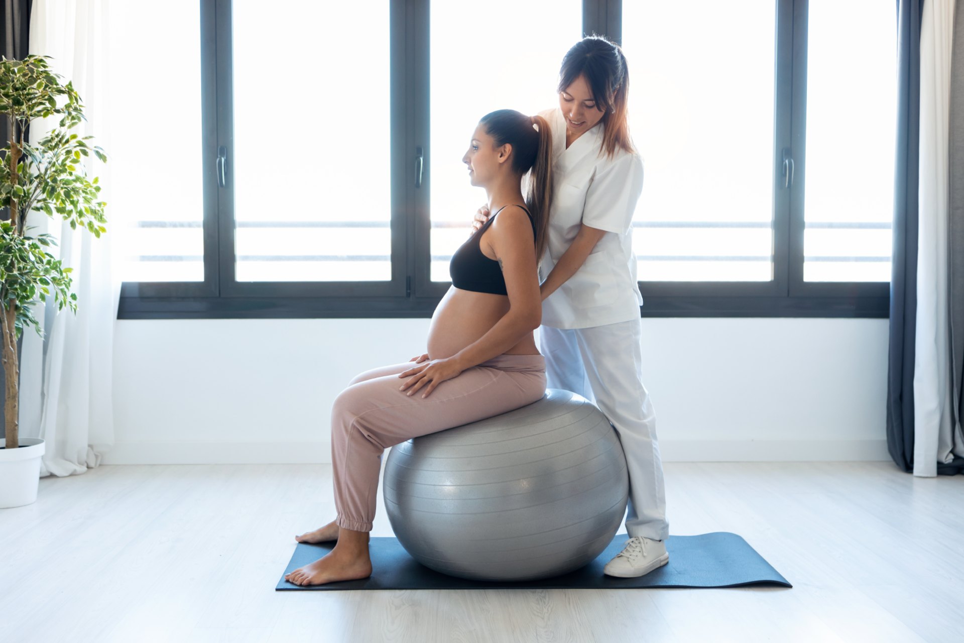 Doctor guiding a new mother through postpartum recovery care