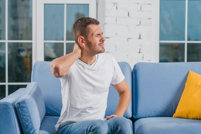 Man holding his neck in discomfort after a car accident